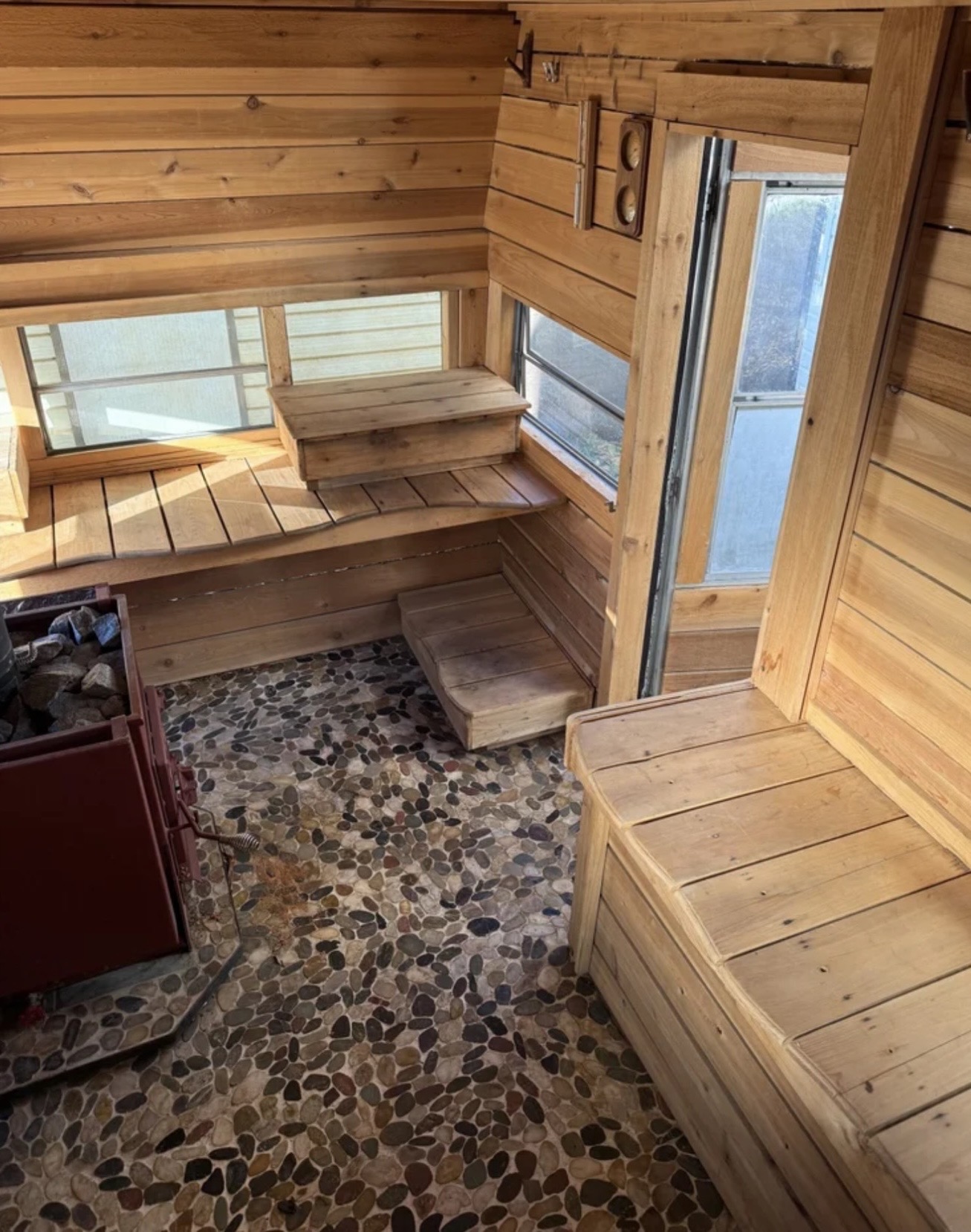 Inside — cedar benches, river stone, Nippa stove